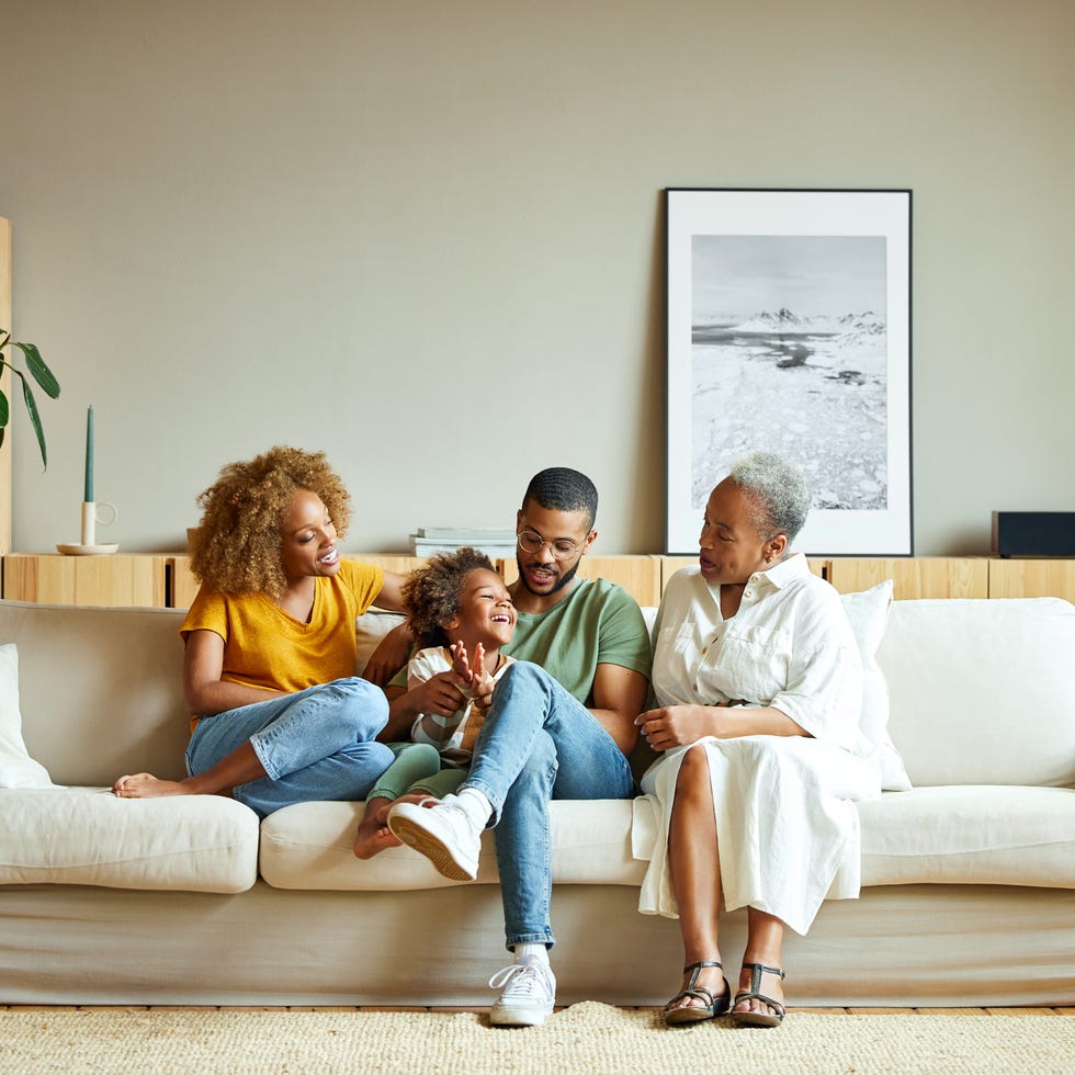 a family sitting on a couch together a family sitting on a couch together