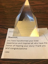 Photo of Transforming Lived Experience award, with note: Shannon, you have transformed your lived experience and inspired all who have the honor of hearing your story! Thank you and congratulations! --AAS"